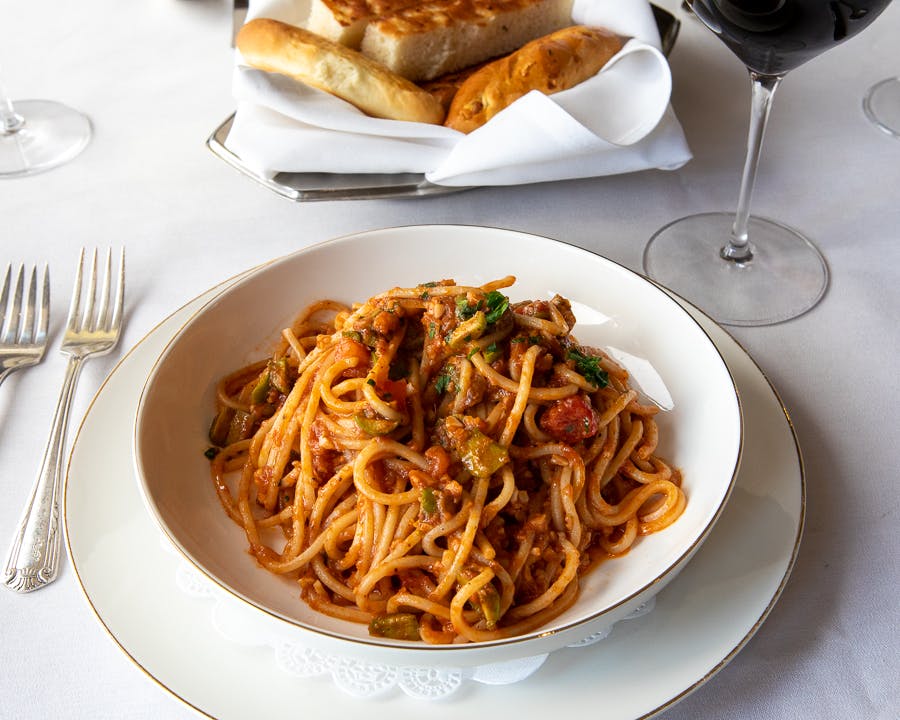 a plate of food and a glass of wine