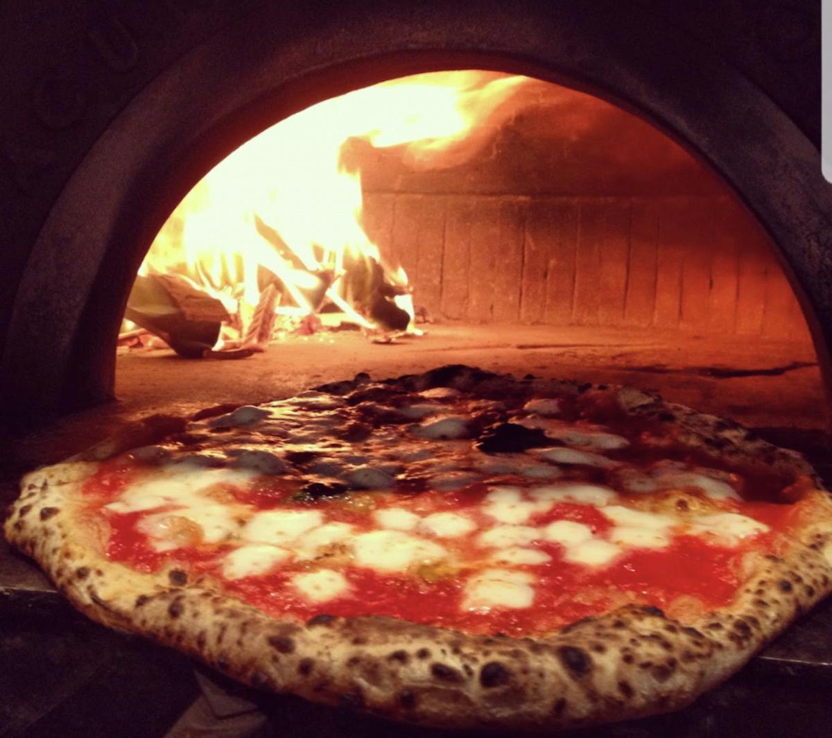 a pizza sitting on top of an oven