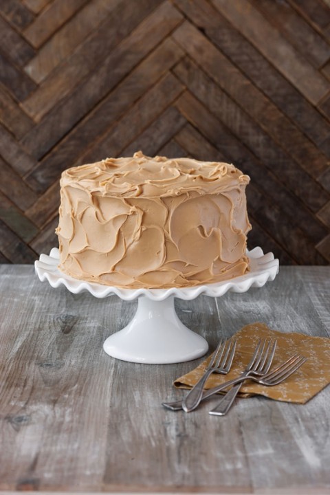 a wooden cutting board with a cake