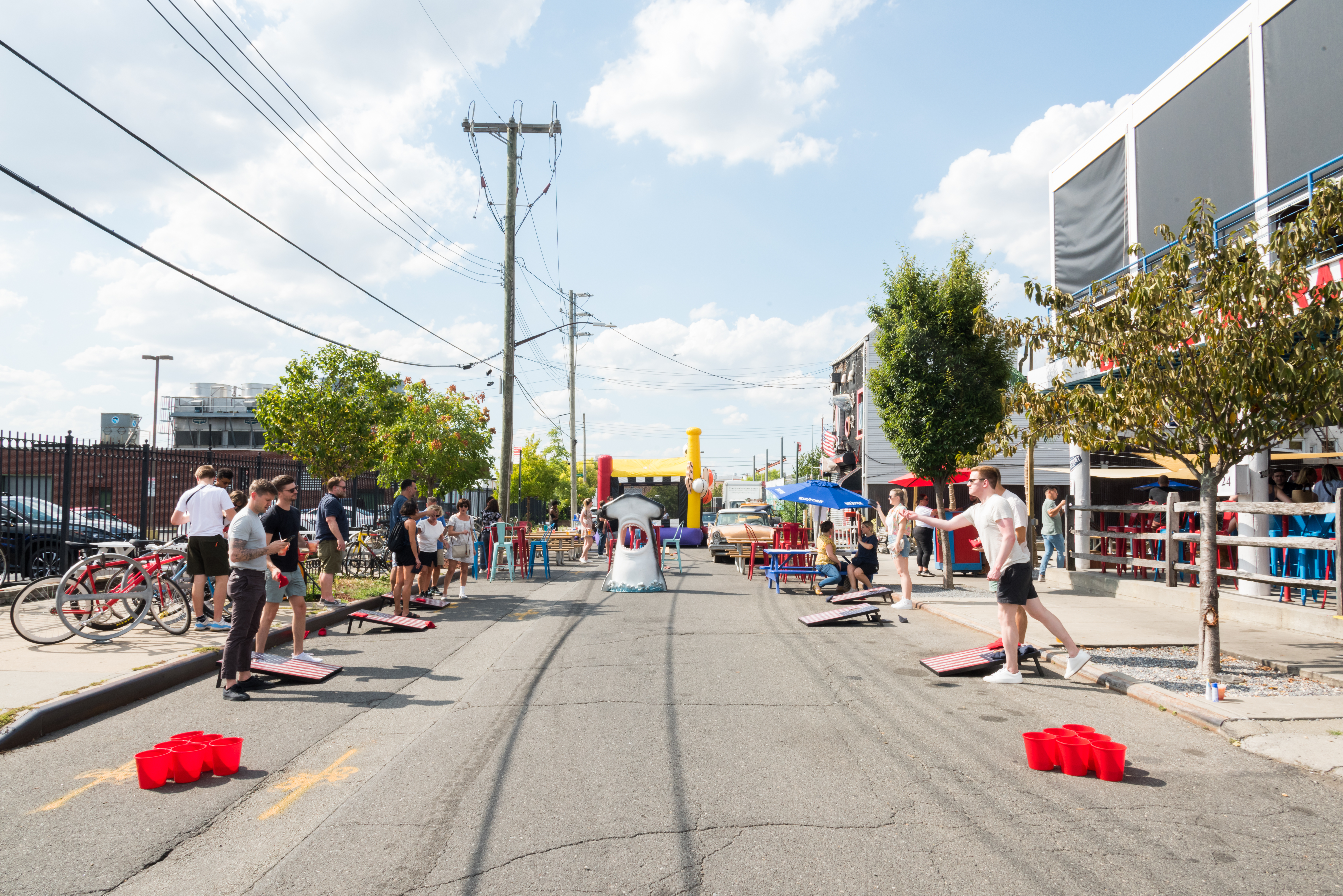 a group of people standing in a parking lot