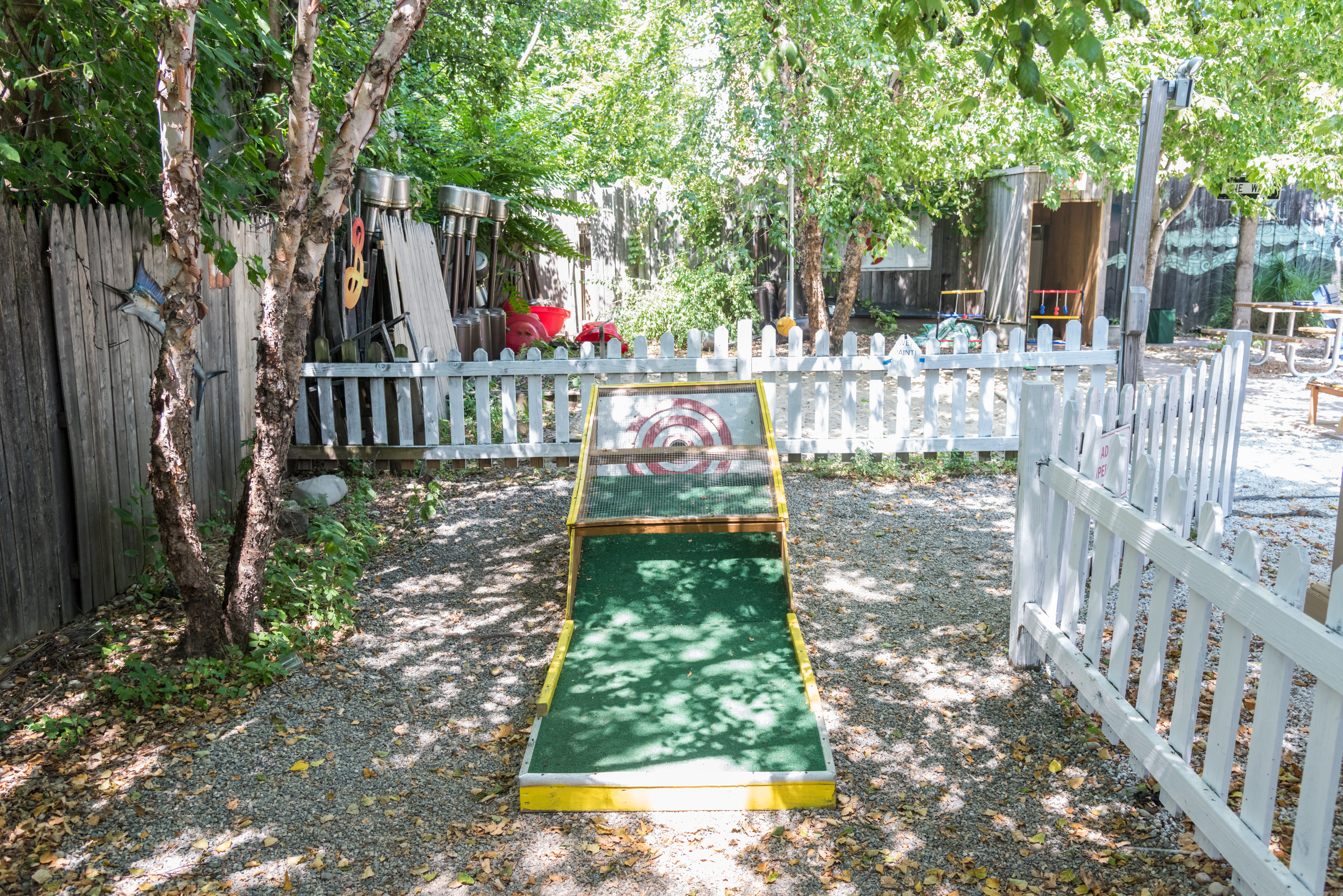 a wooden bench sitting next to a fence