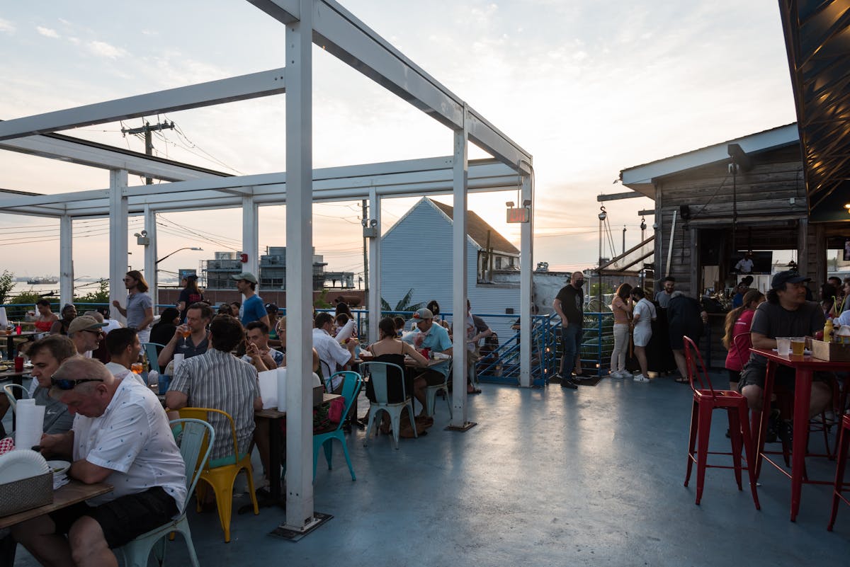 a group of people sitting at a table in front of a building