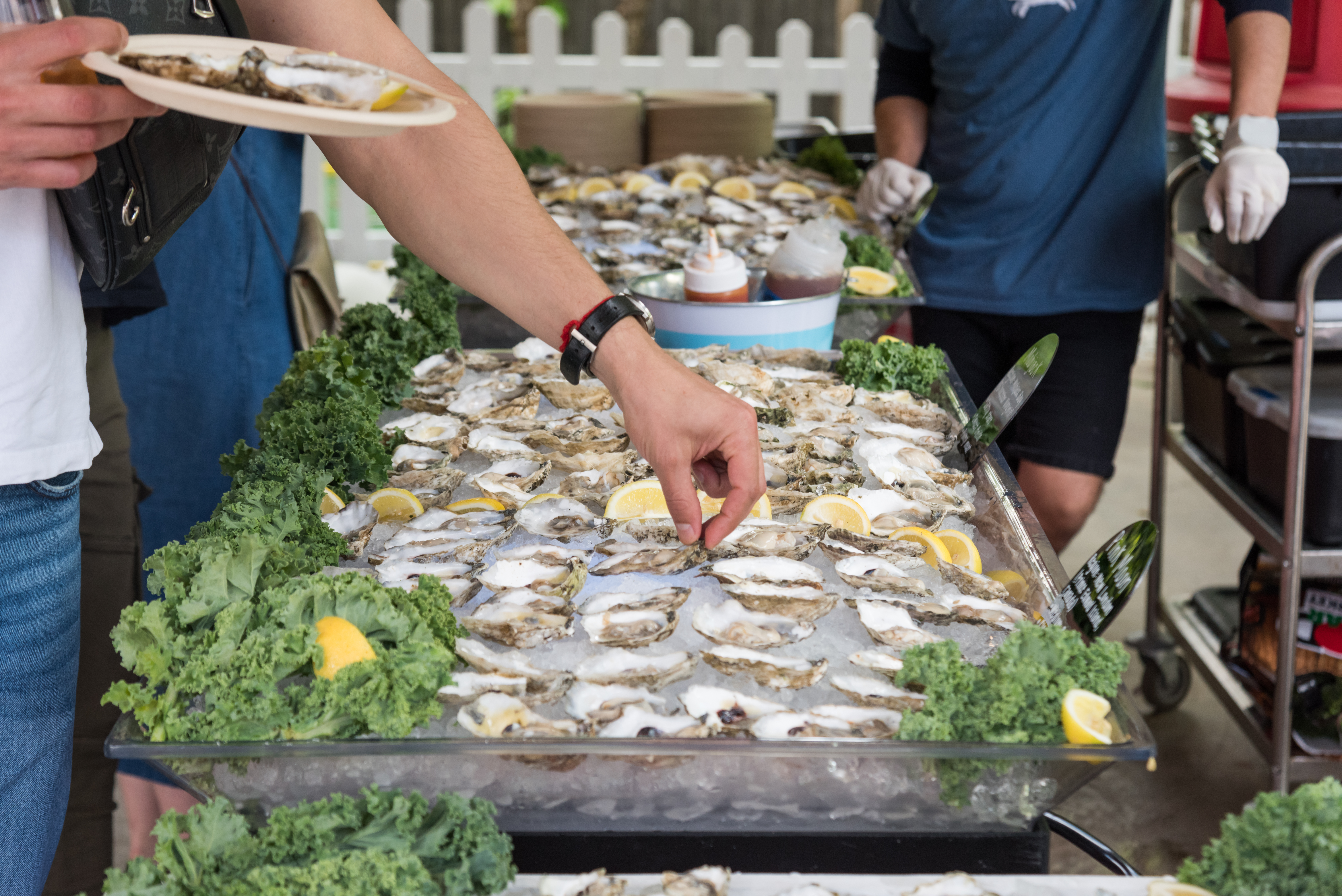 a person holding a plate of food with a knife