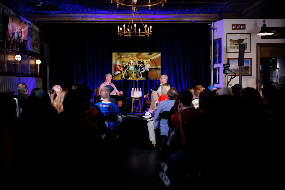 a group of people in a room with a television screen