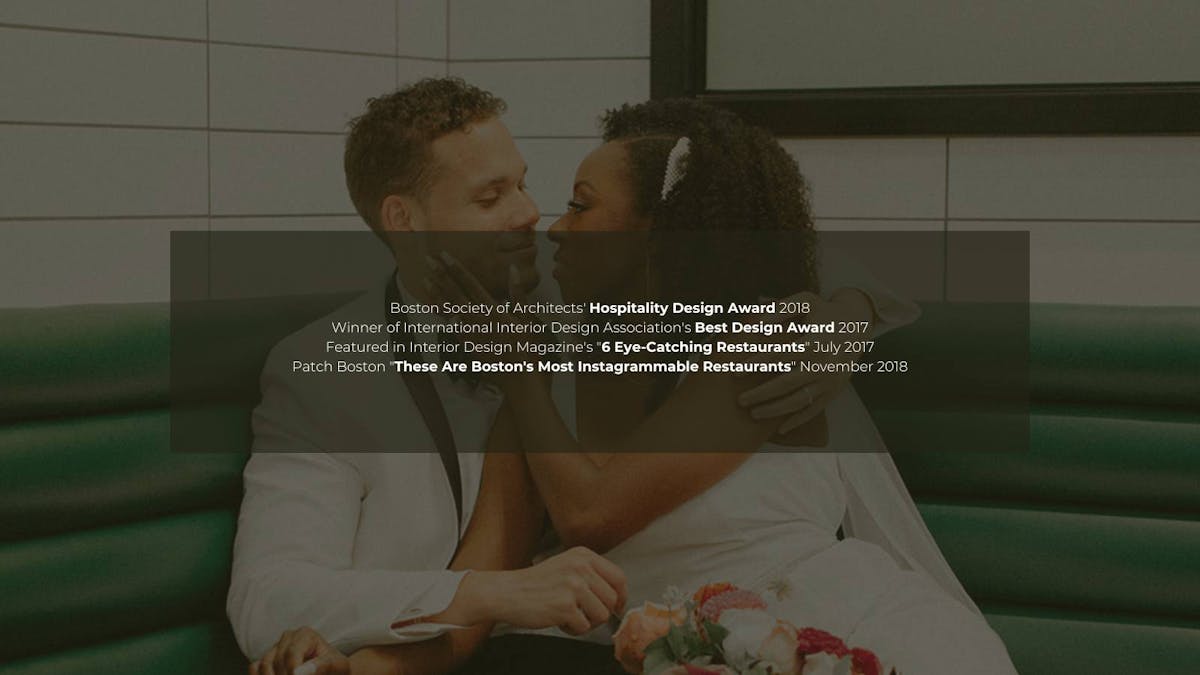 a man and a woman sitting on a bed