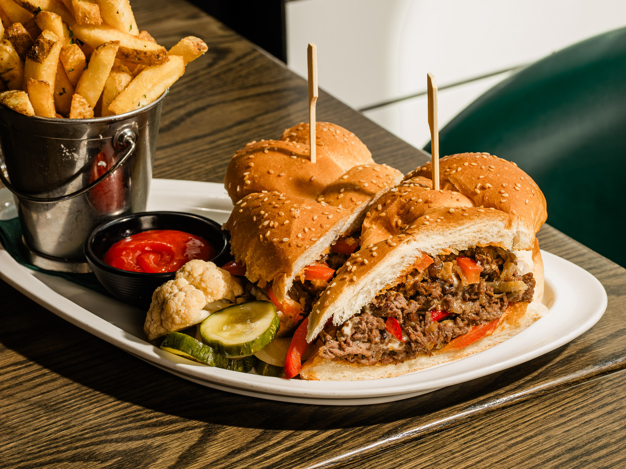 a plate of food with a bucket of fries and a sandwich