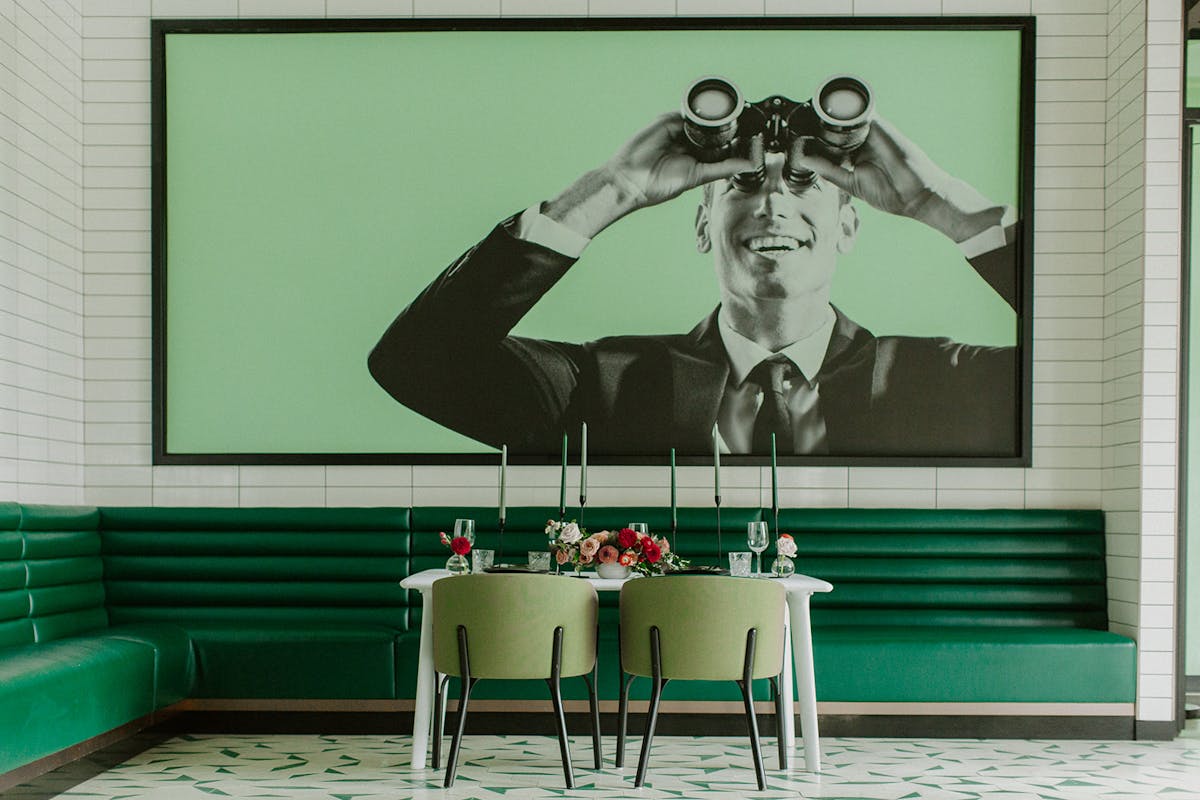 a green chair in front of a window