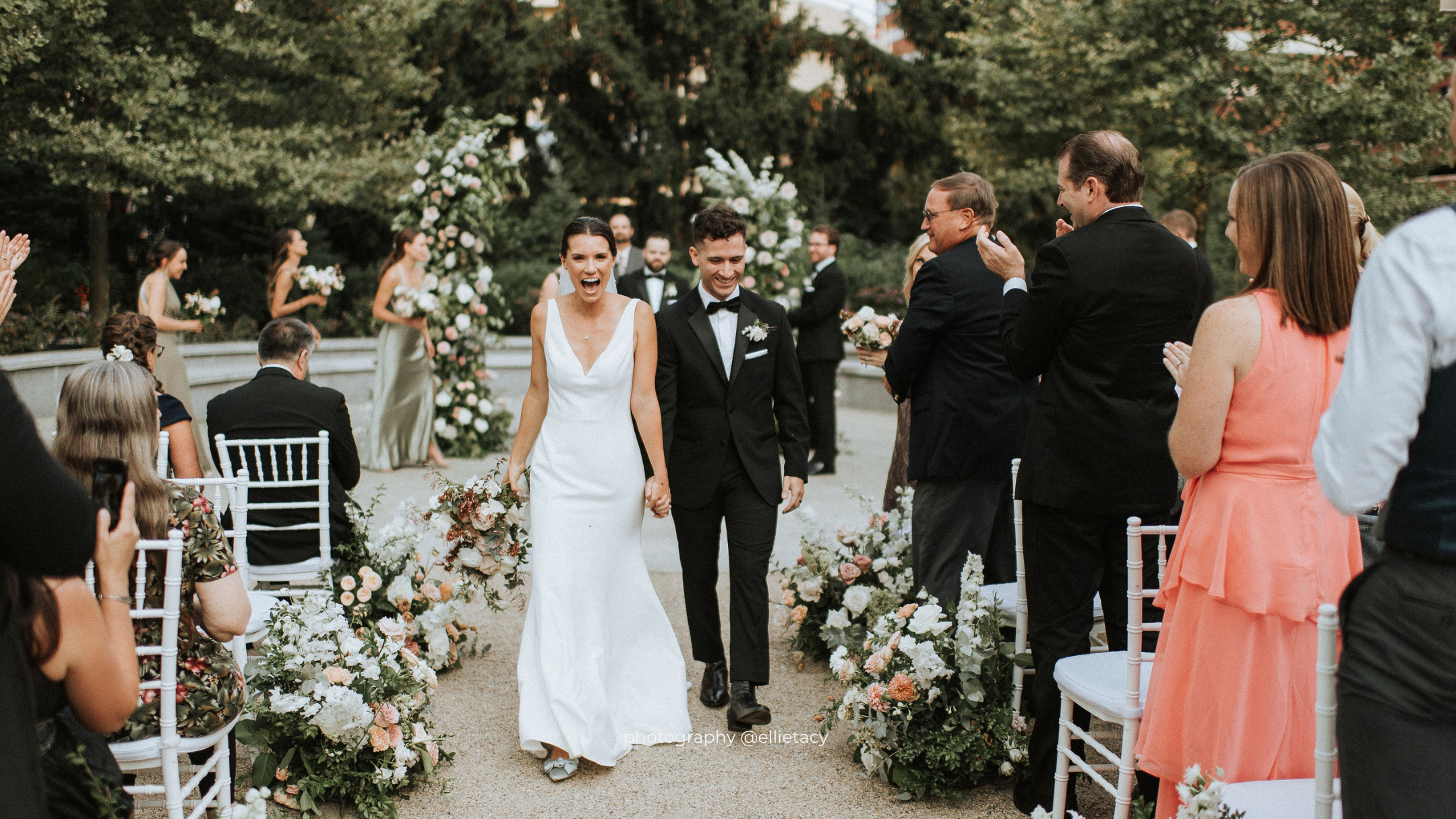 a group of people standing next to a person in a wedding dress