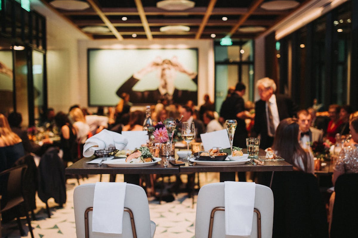 a group of people sitting at a table in a restaurant