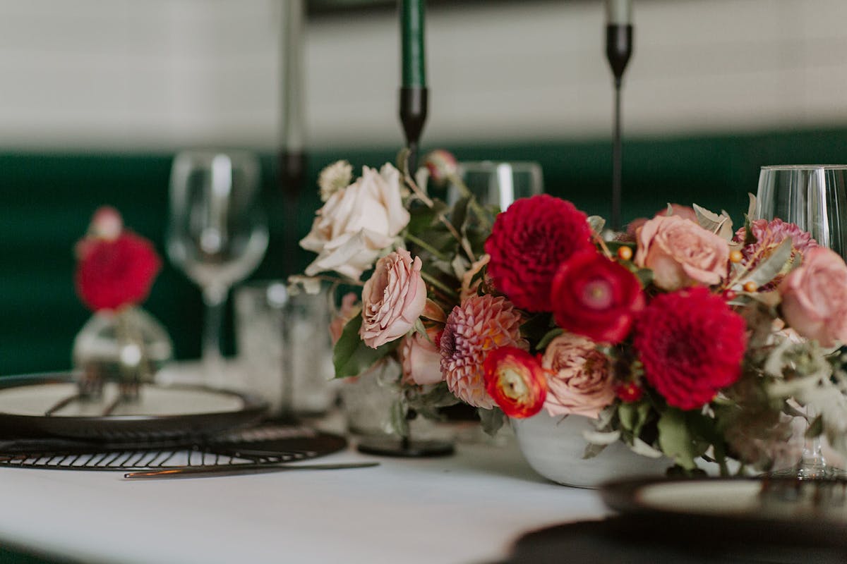 a close up of a vase of flowers on a table