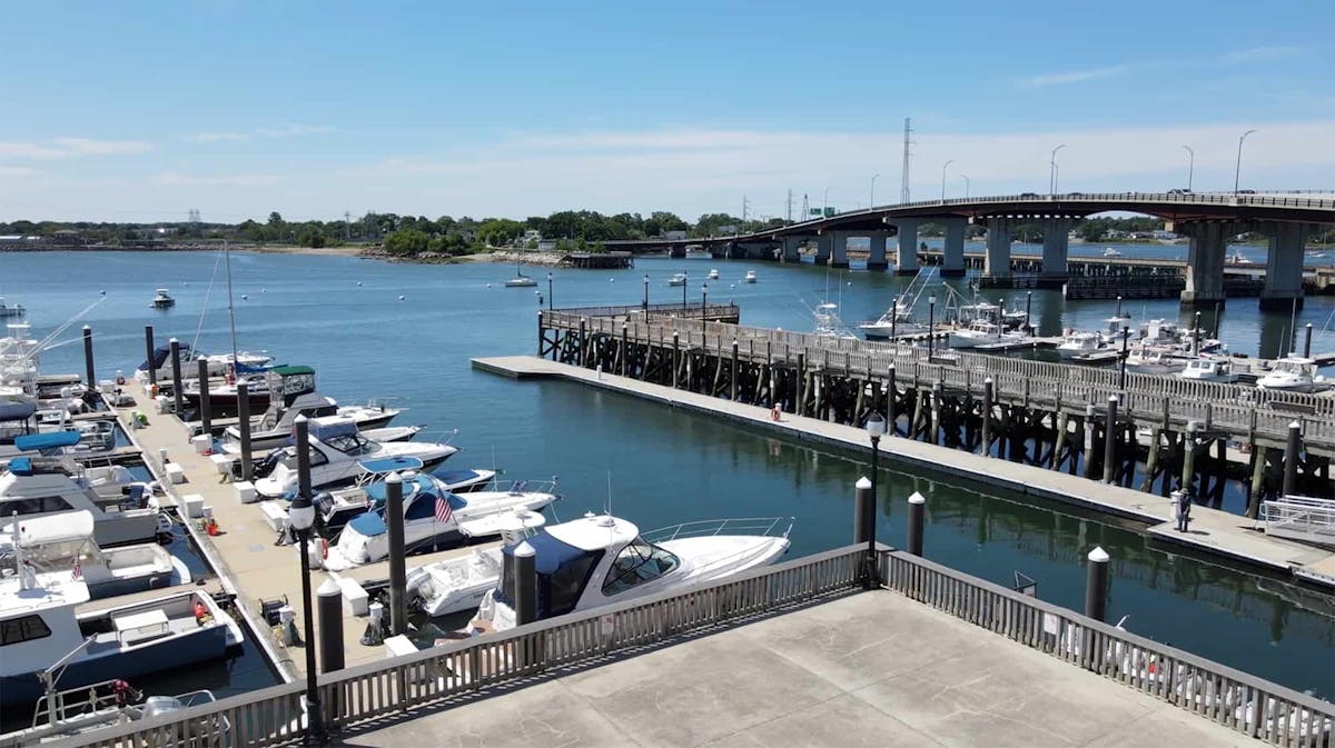 a group of people sitting at a dock