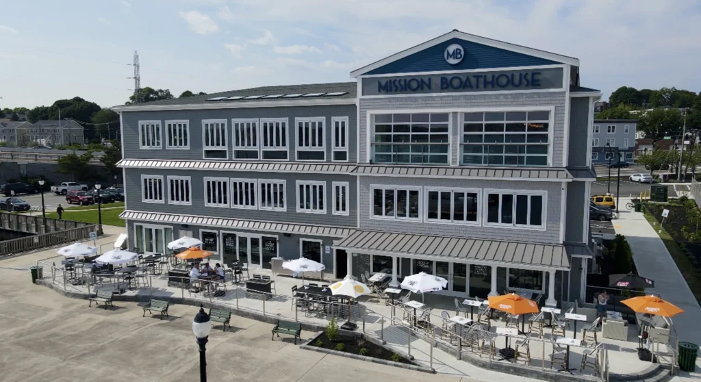 a large building with a clock on the side of a road