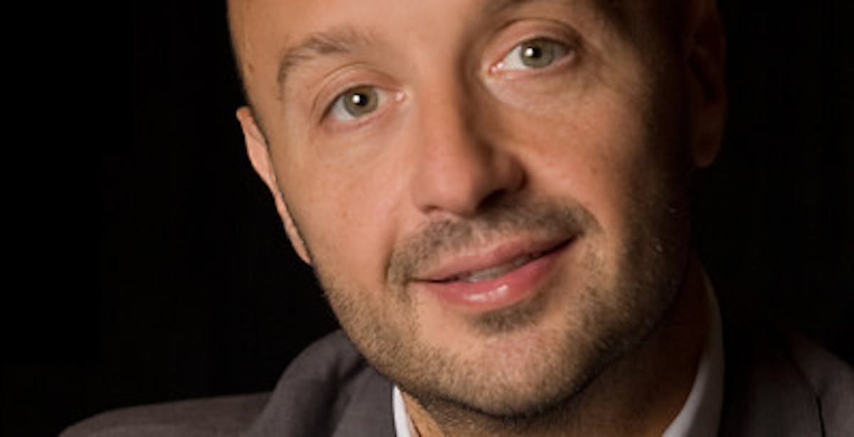 a close up of Joe Bastianich who is smiling and looking at the camera