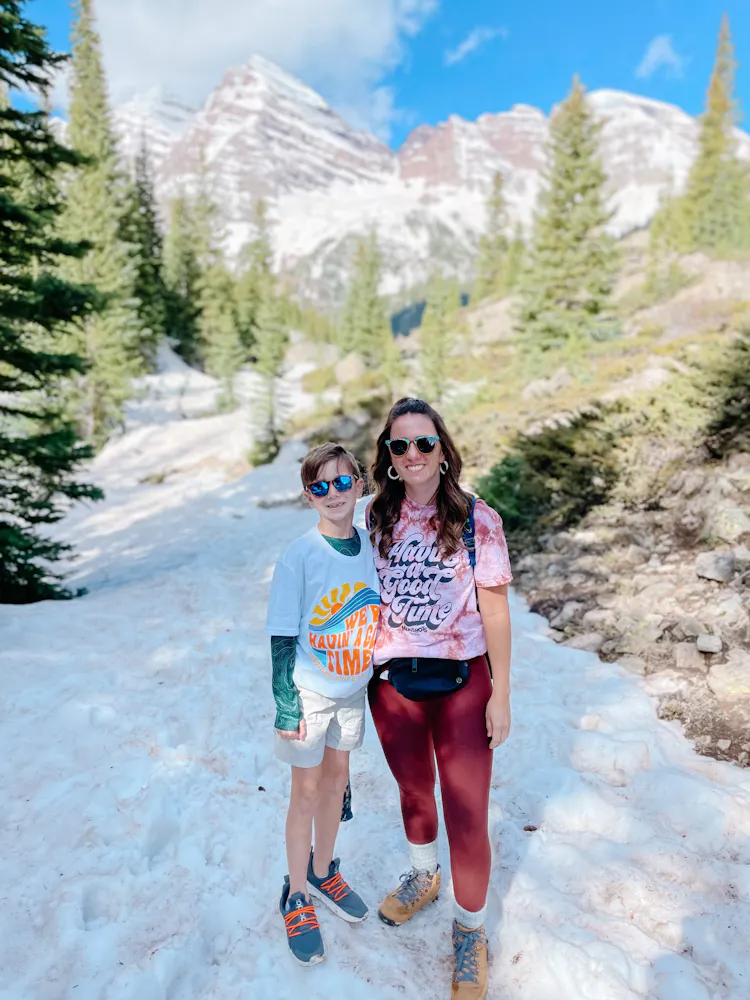 a woman standing on a snow covered mountain
