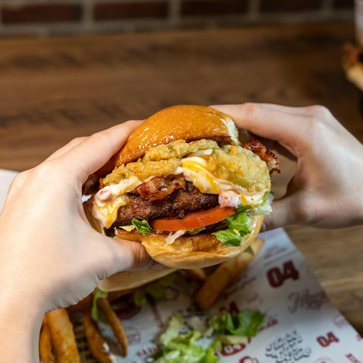 a person holding a burger