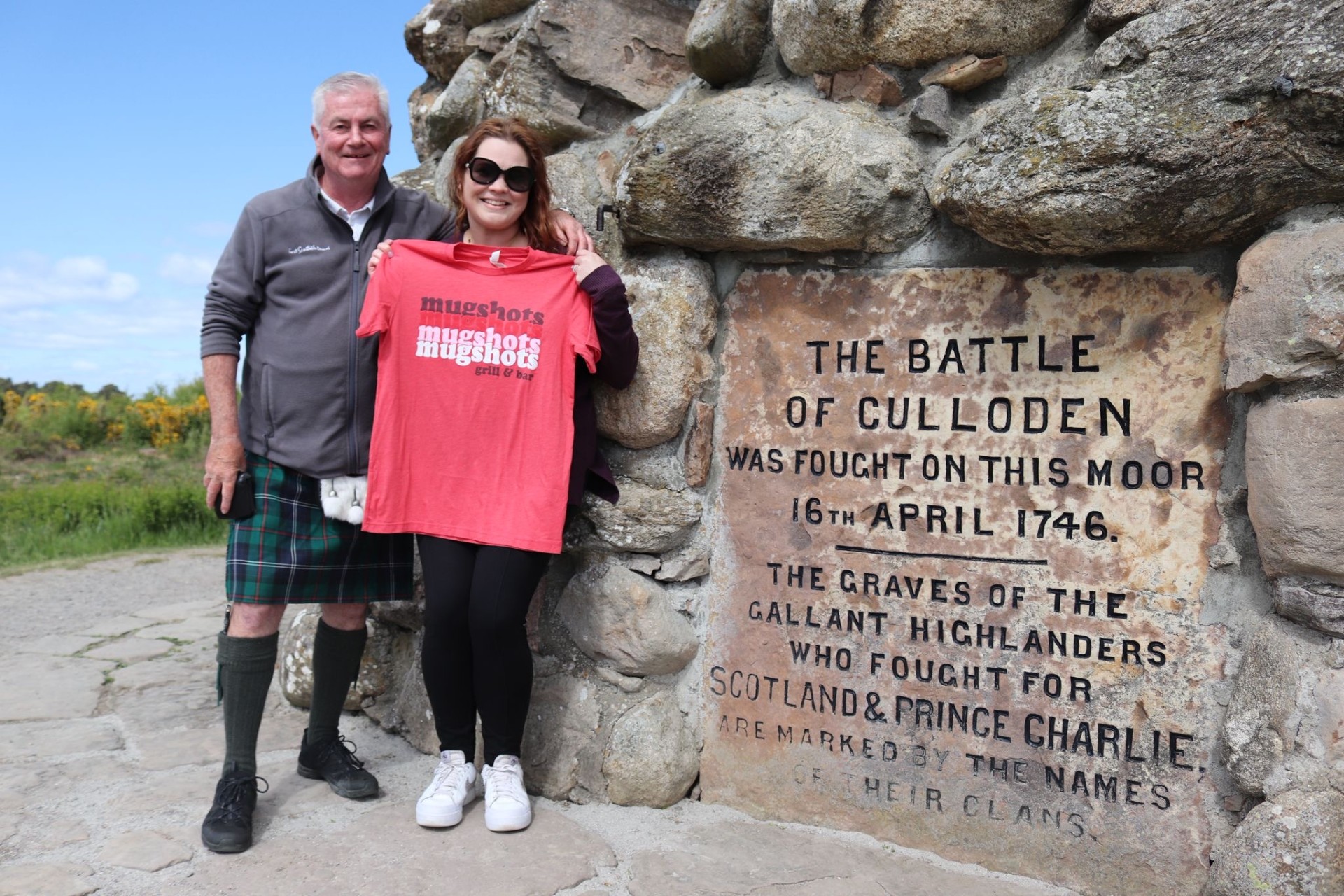 a person standing in front of a large rock
