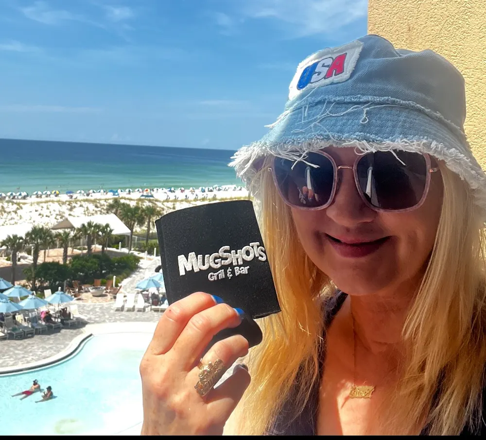 a woman wearing sunglasses posing for the camera