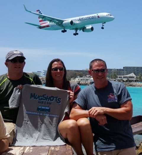 a group of people standing around a plane