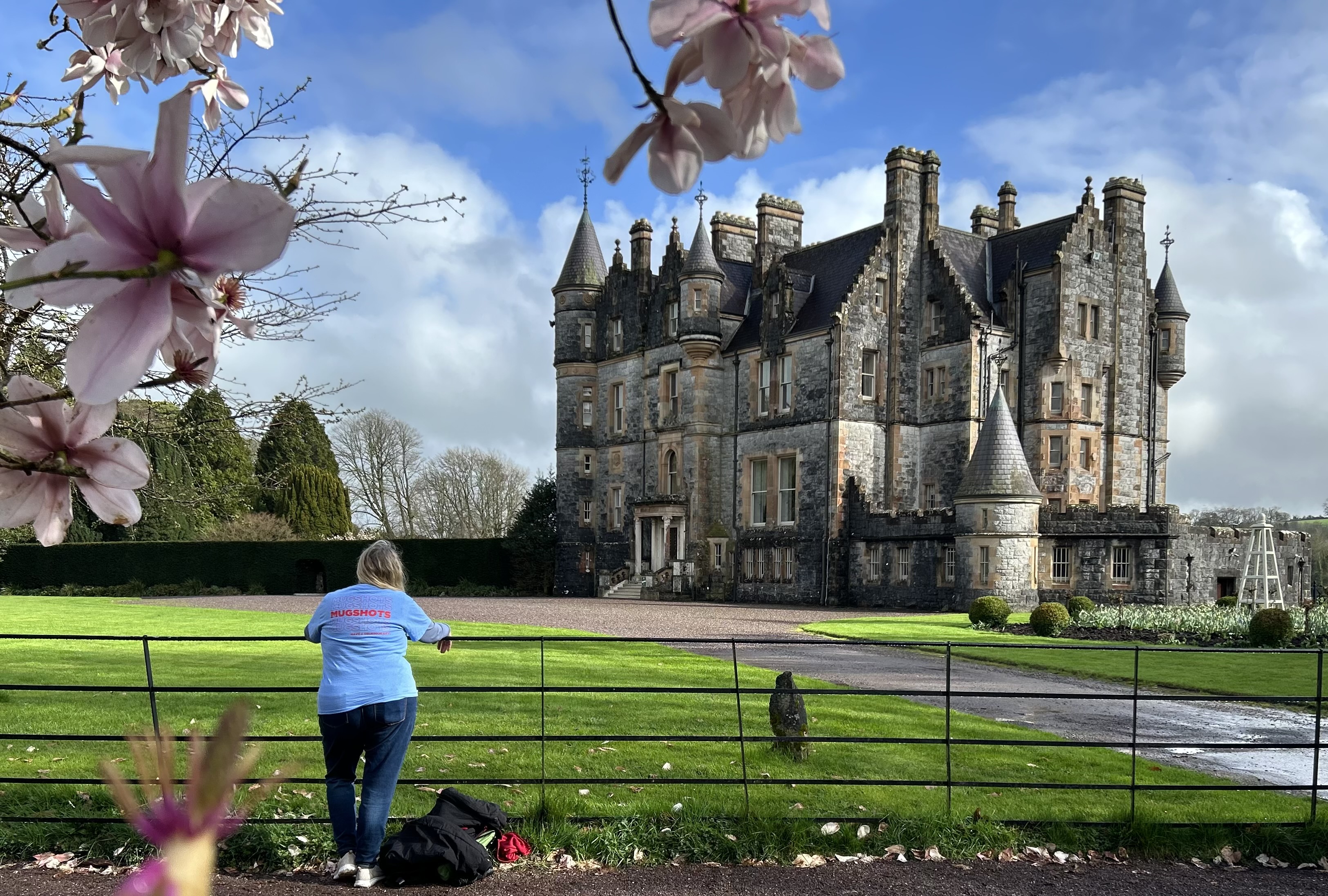 a woman standing in front of a fence