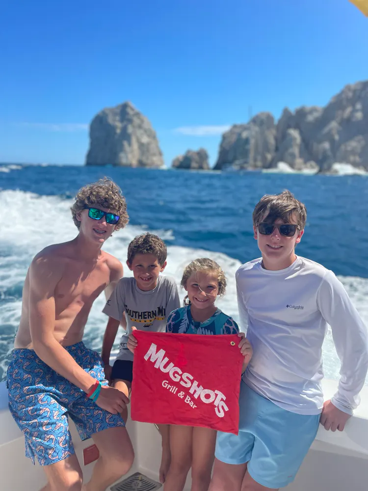 a group of people standing next to a body of water