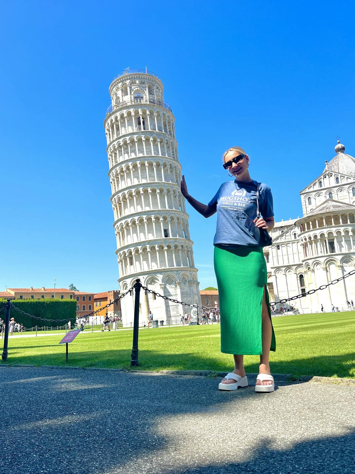 a person standing in front of Leaning Tower of Pisa