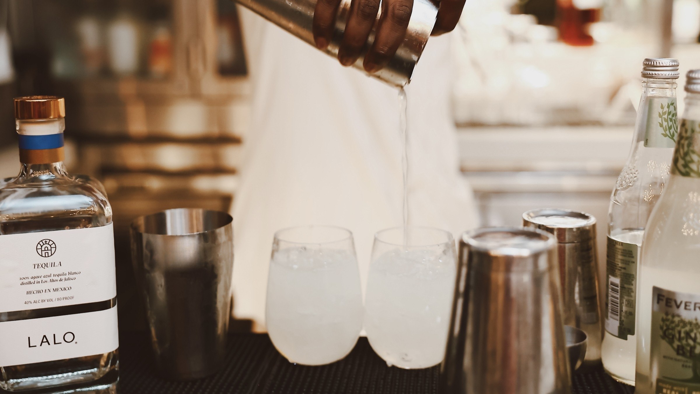 Bartender pouring hand-crafted tequila cocktail at Z on 23 bar