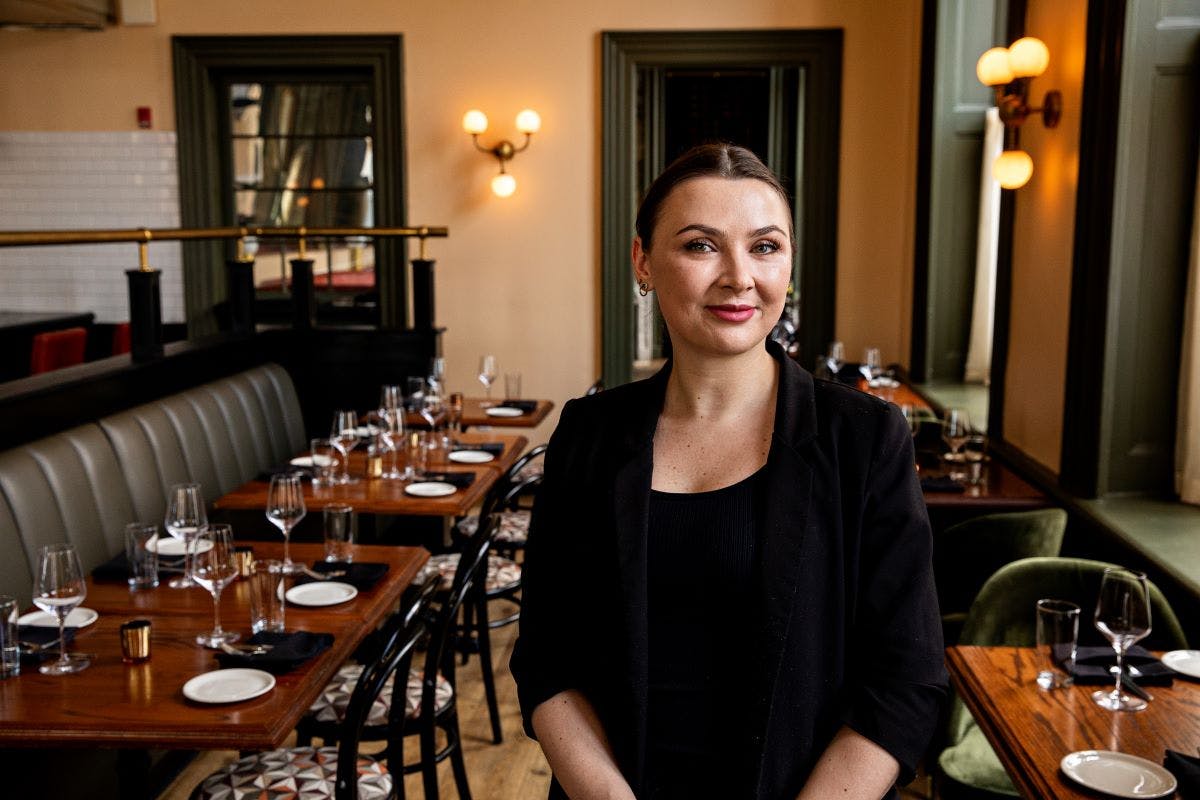 a woman sitting at a table in a restaurant