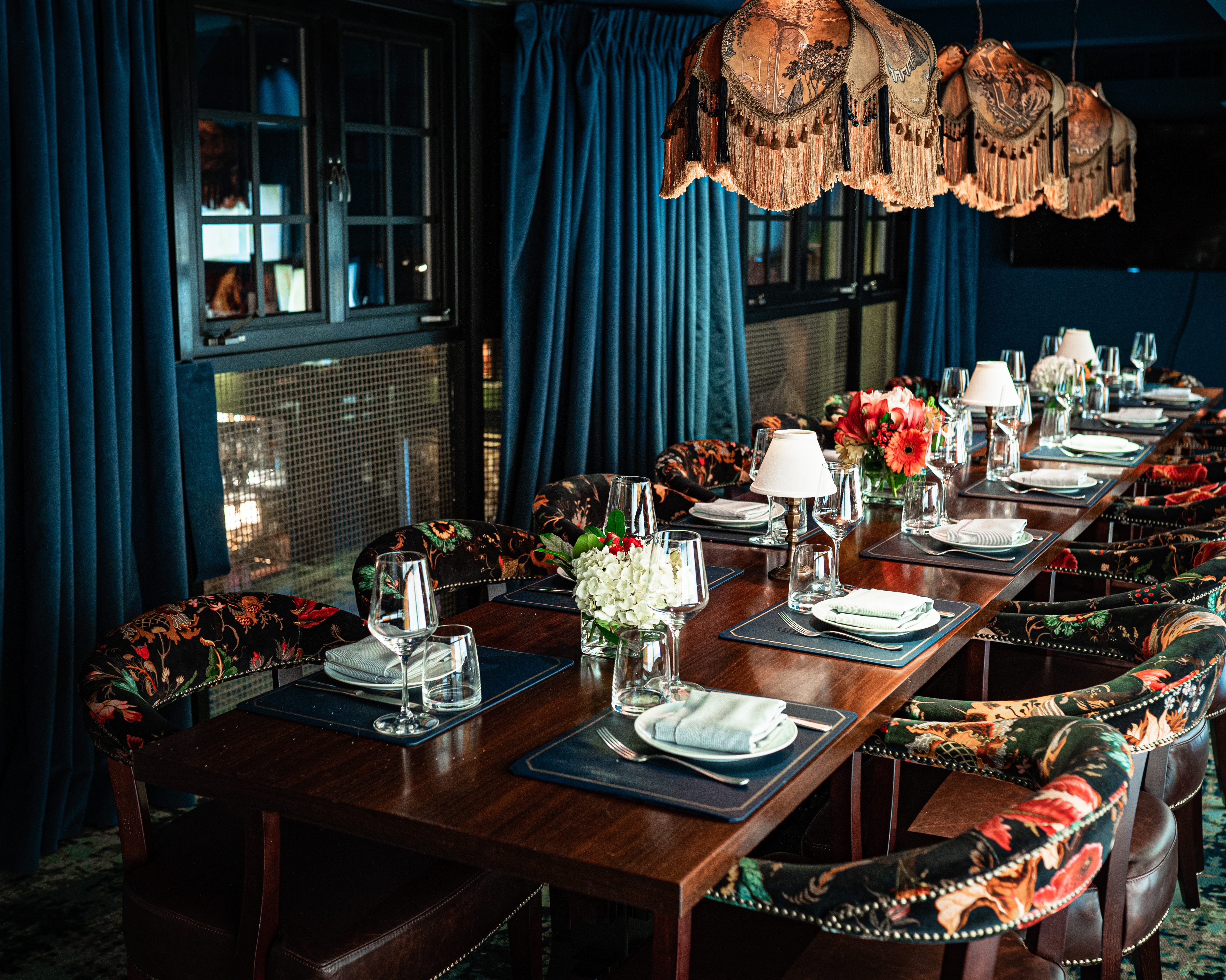 a room filled with furniture and vase of flowers on a table