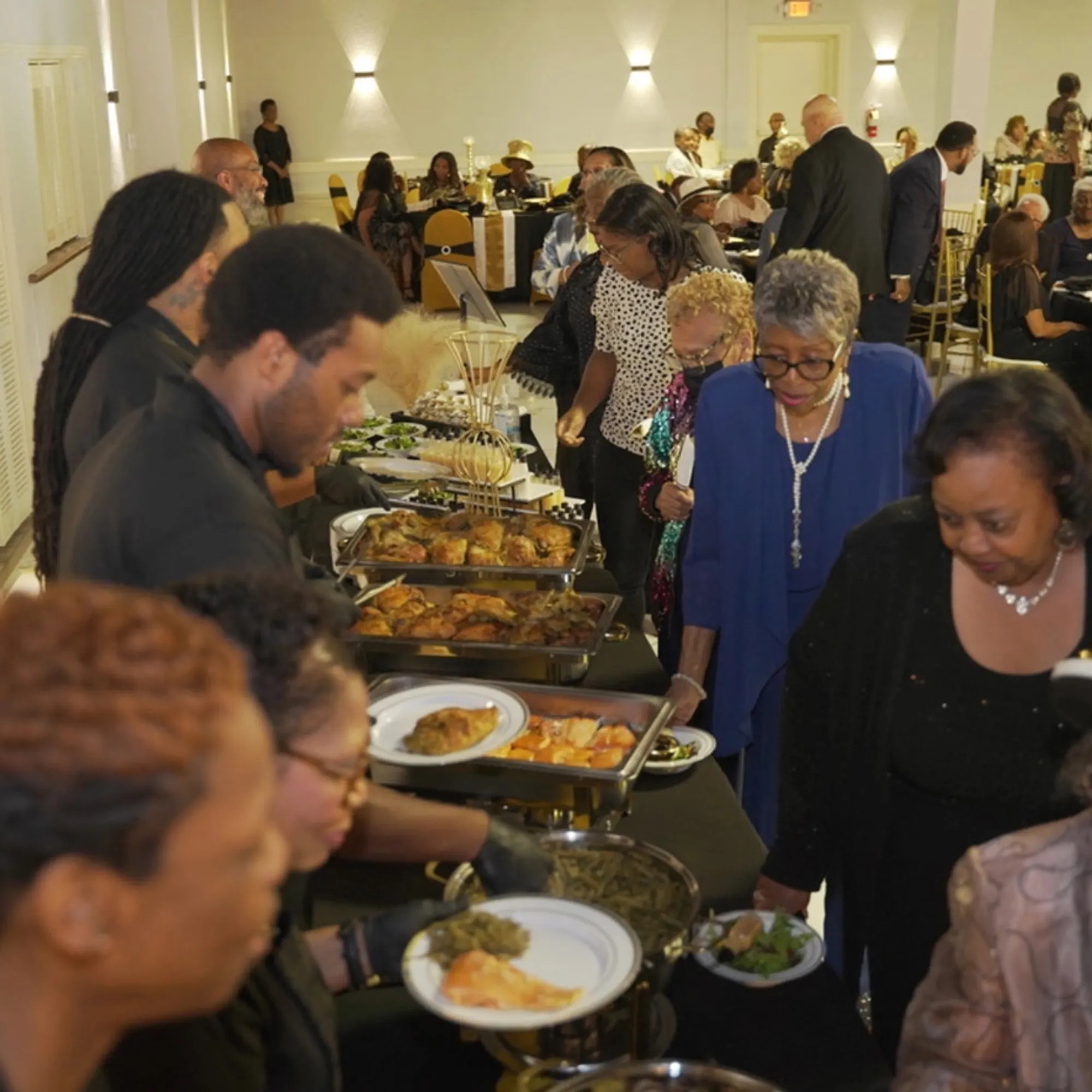 a group of people sitting around a long table eating