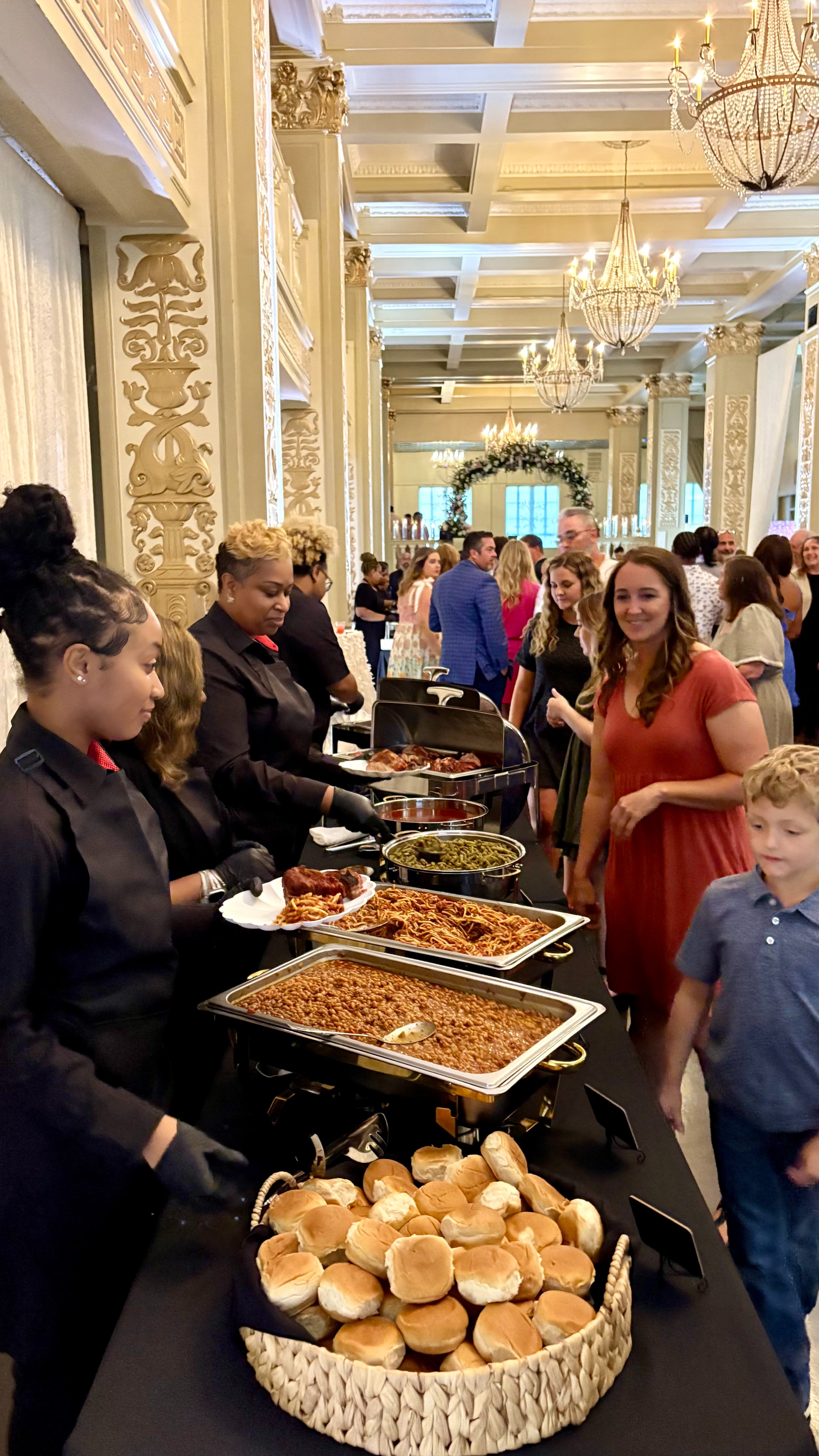a group of people sitting at a table with food