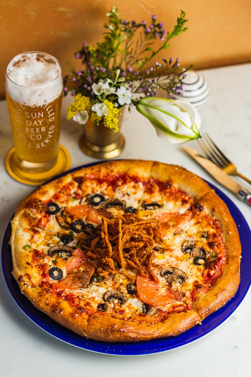 a pizza sitting on top of a plate of food