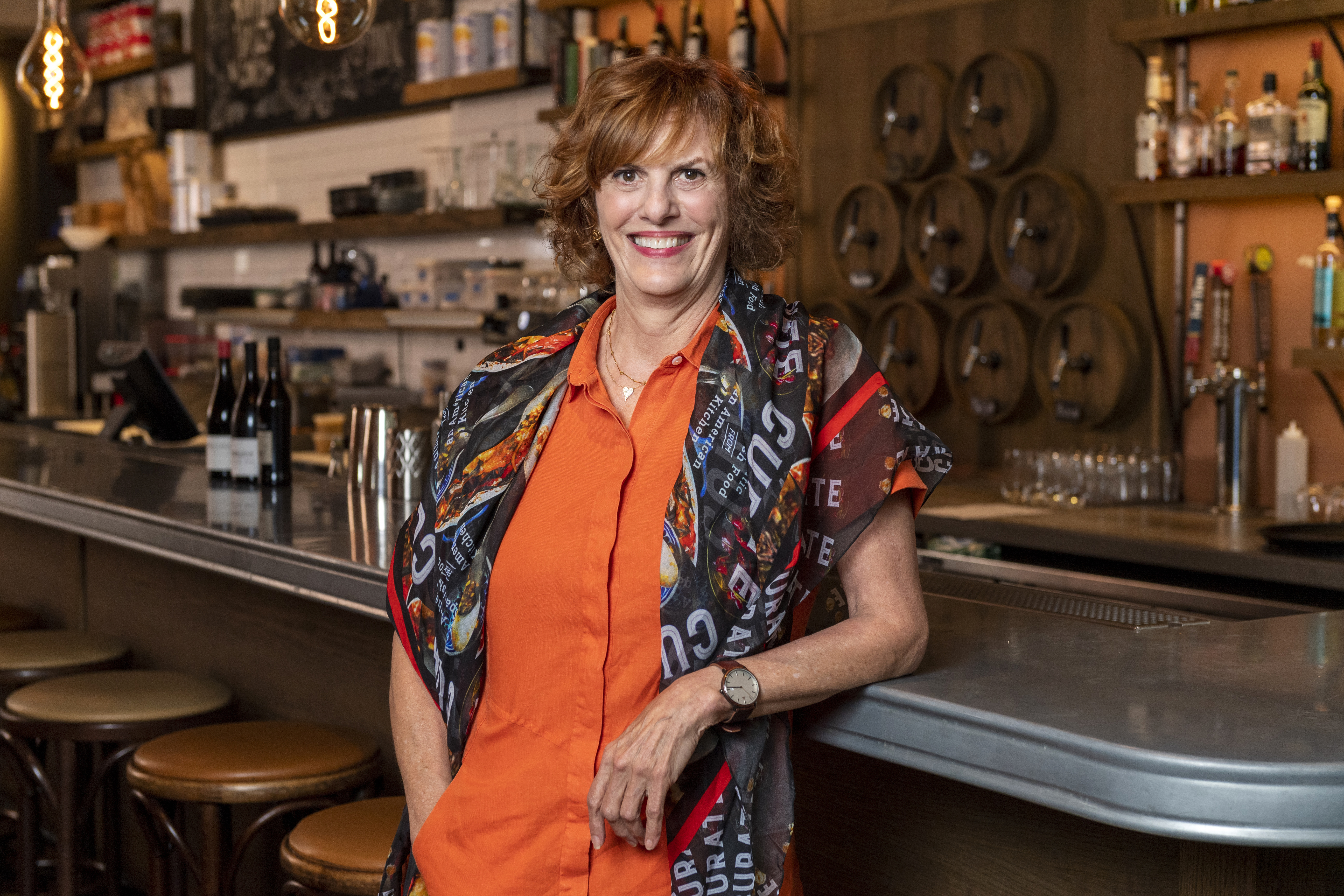 a woman standing at a bar