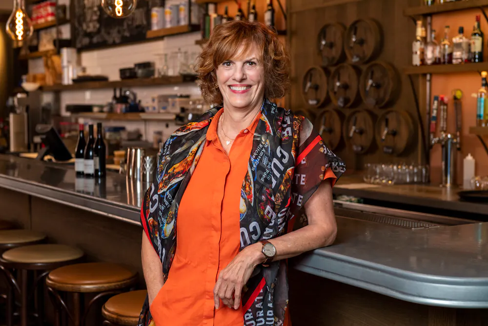 a woman standing at a bar