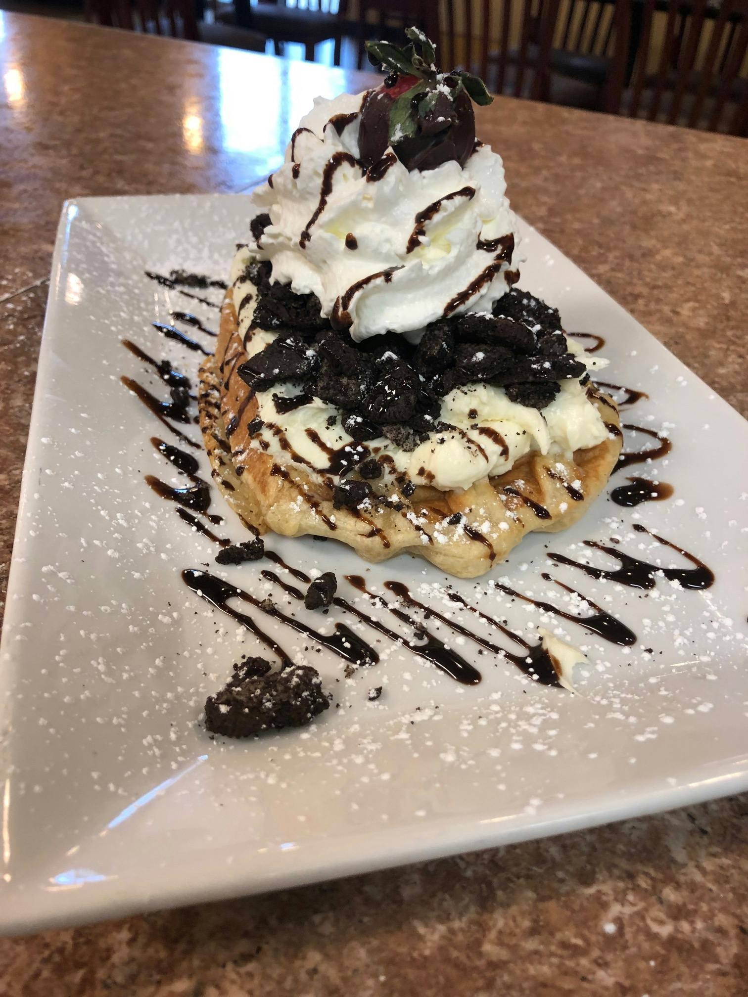 a piece of crepe and ice cream on a plate