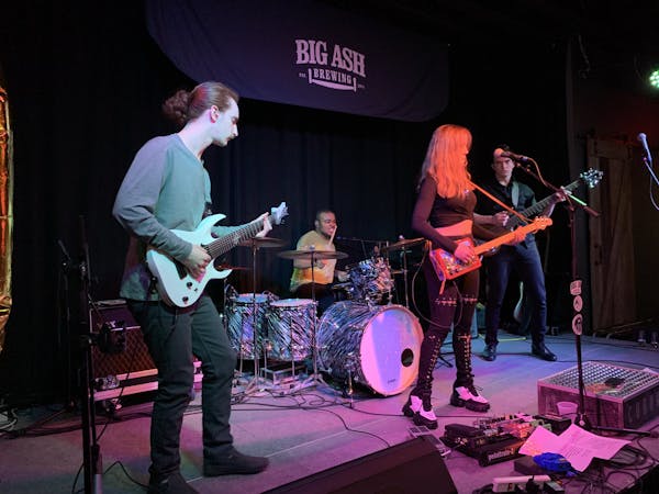 a group of people standing on a stage playing instruments