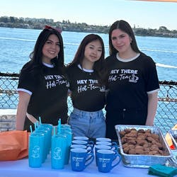 a group of people standing in front of a body of water