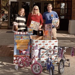 a group of people riding on the back of a bicycle
