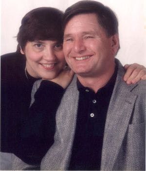 a smiling man and woman posing for a photo