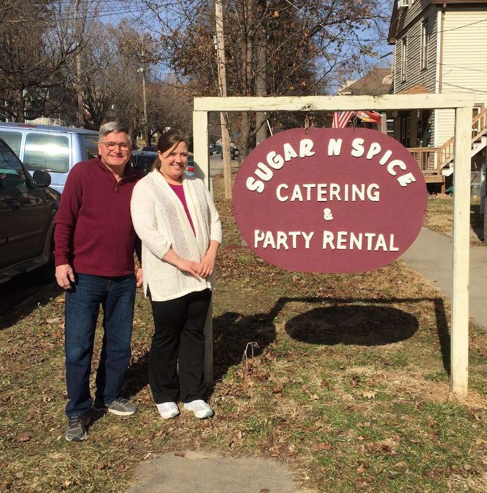 a group of people standing in front of a sign