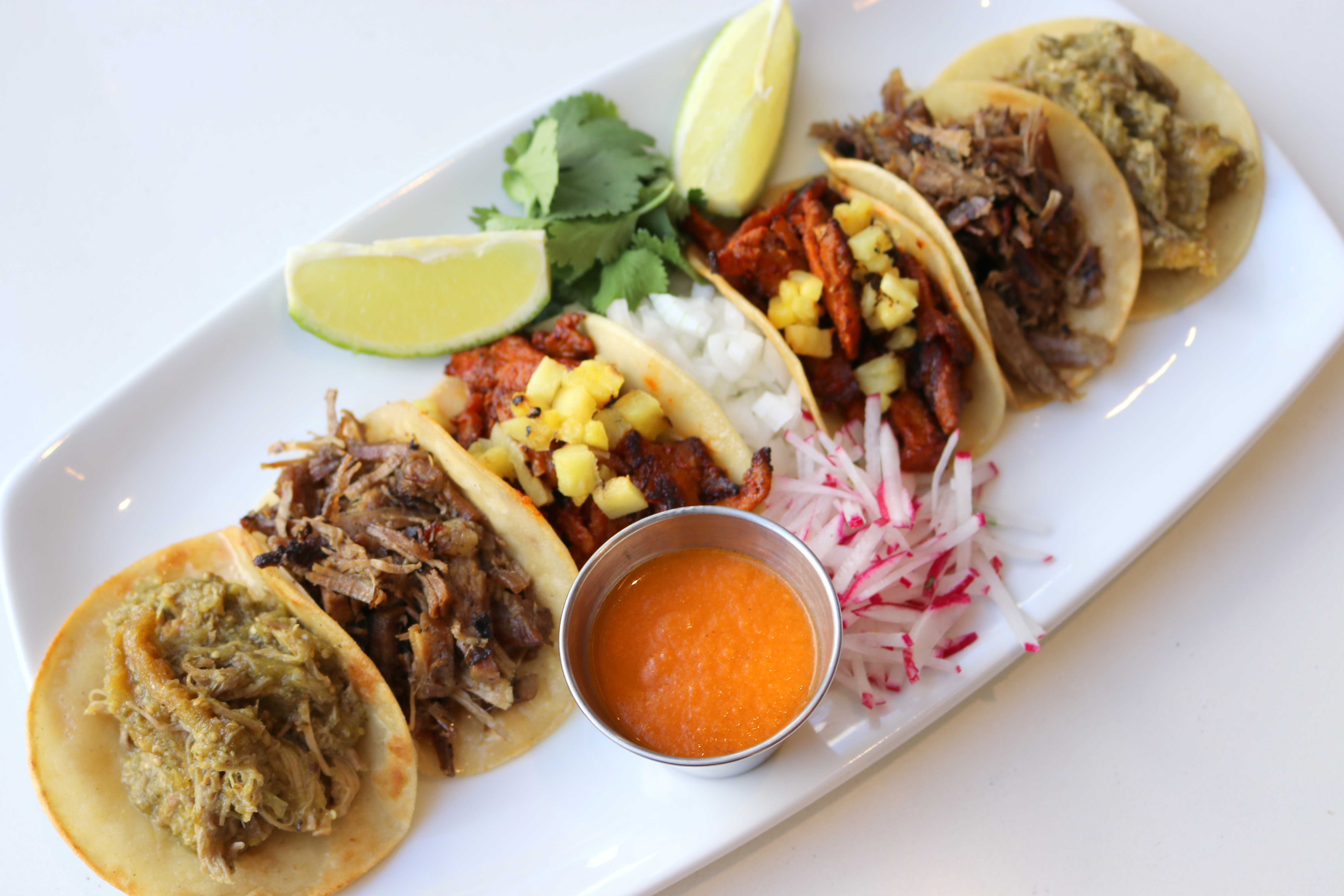 a plate of tacos with meat and vegetables