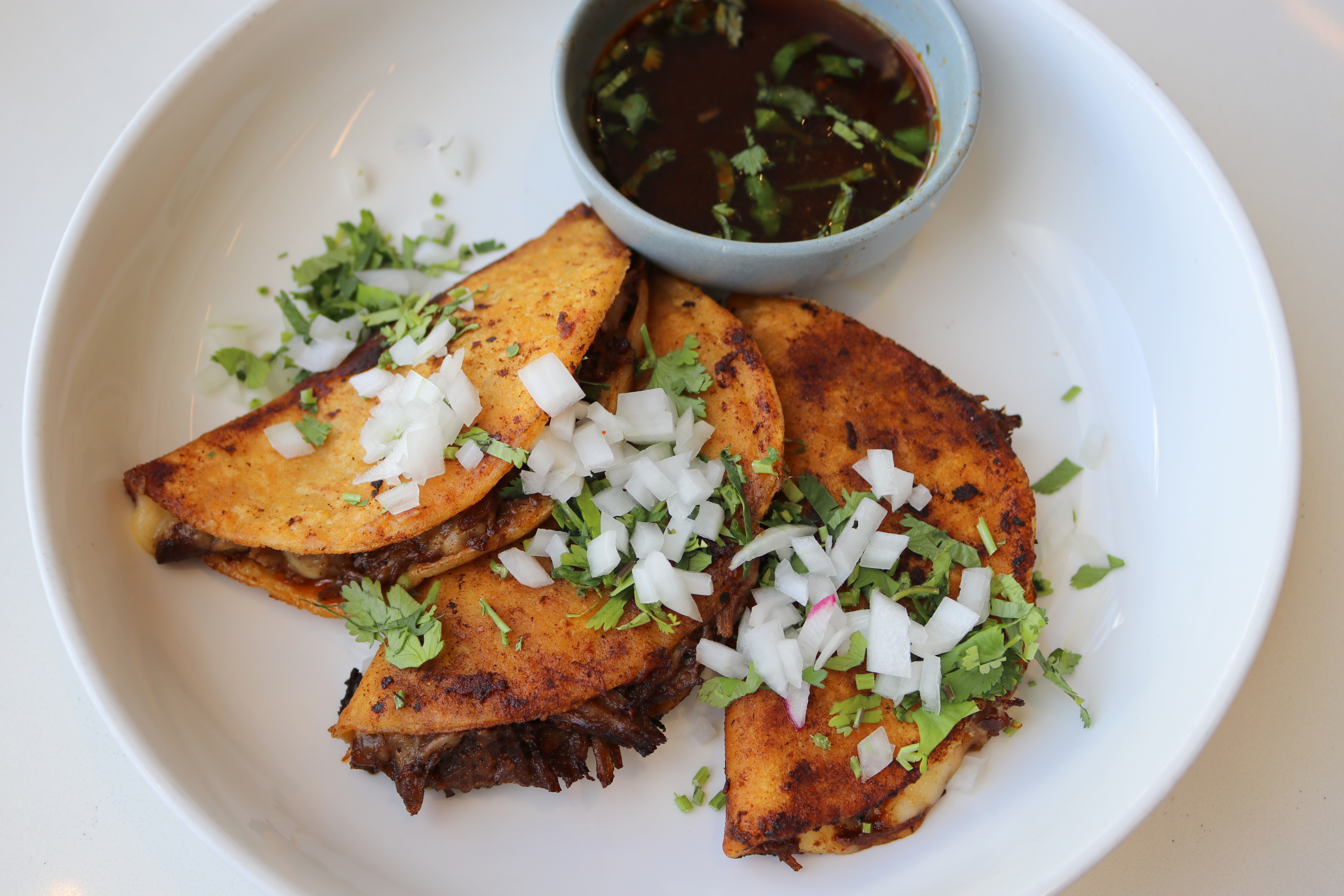 a plate of tacos with sauce