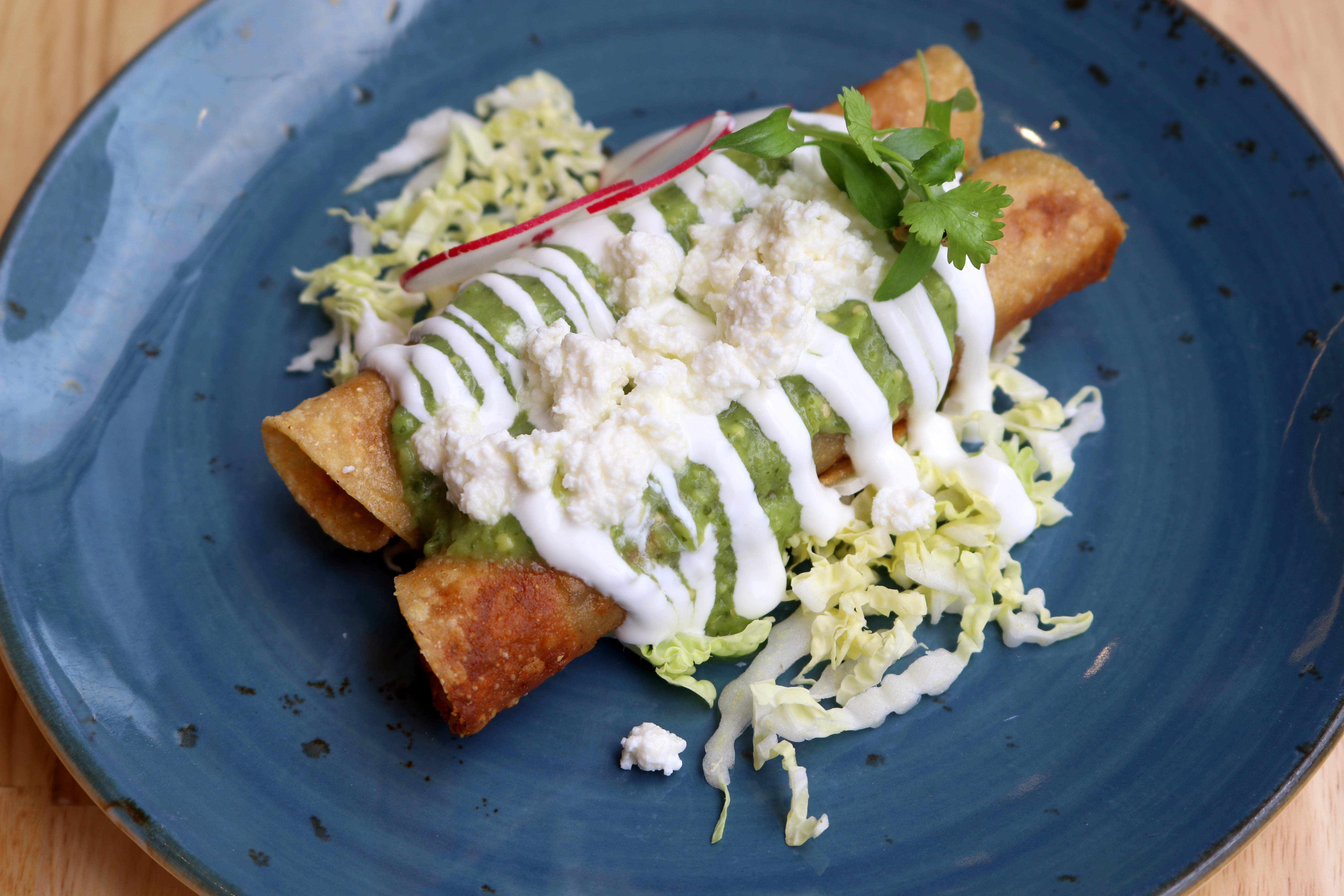 a plate of food with sauce and lettuce