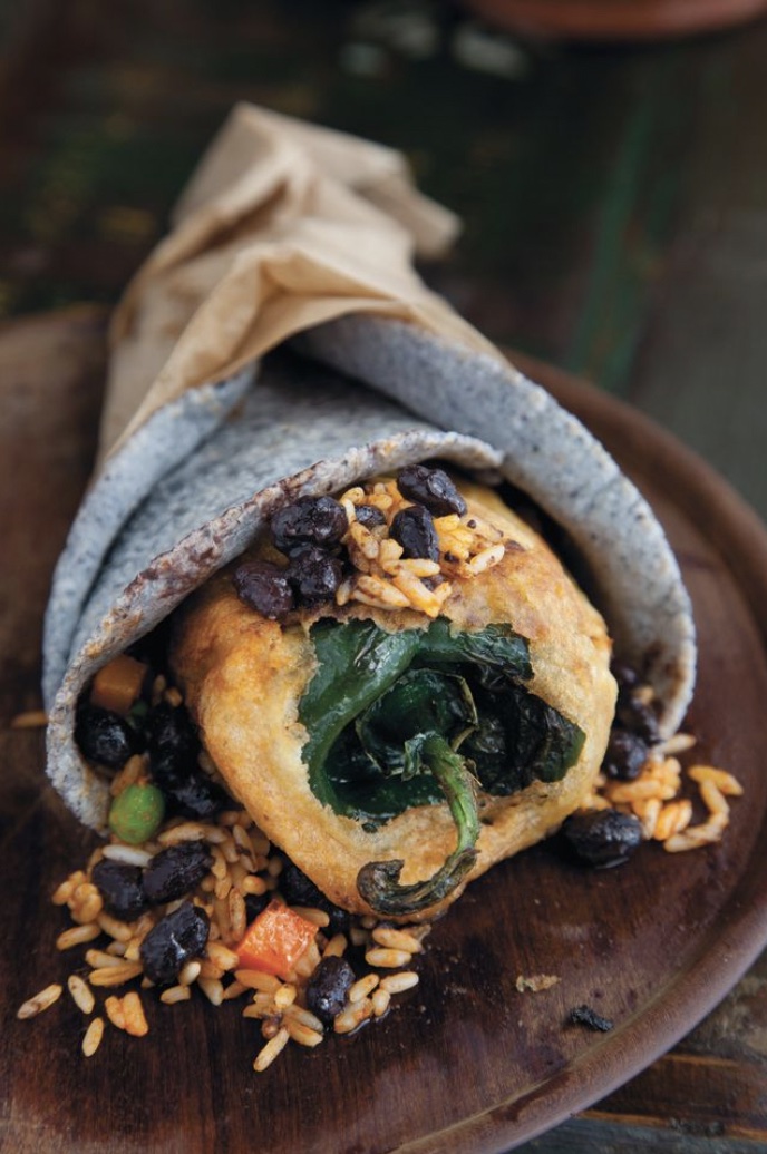 a pizza sitting on top of a wooden table