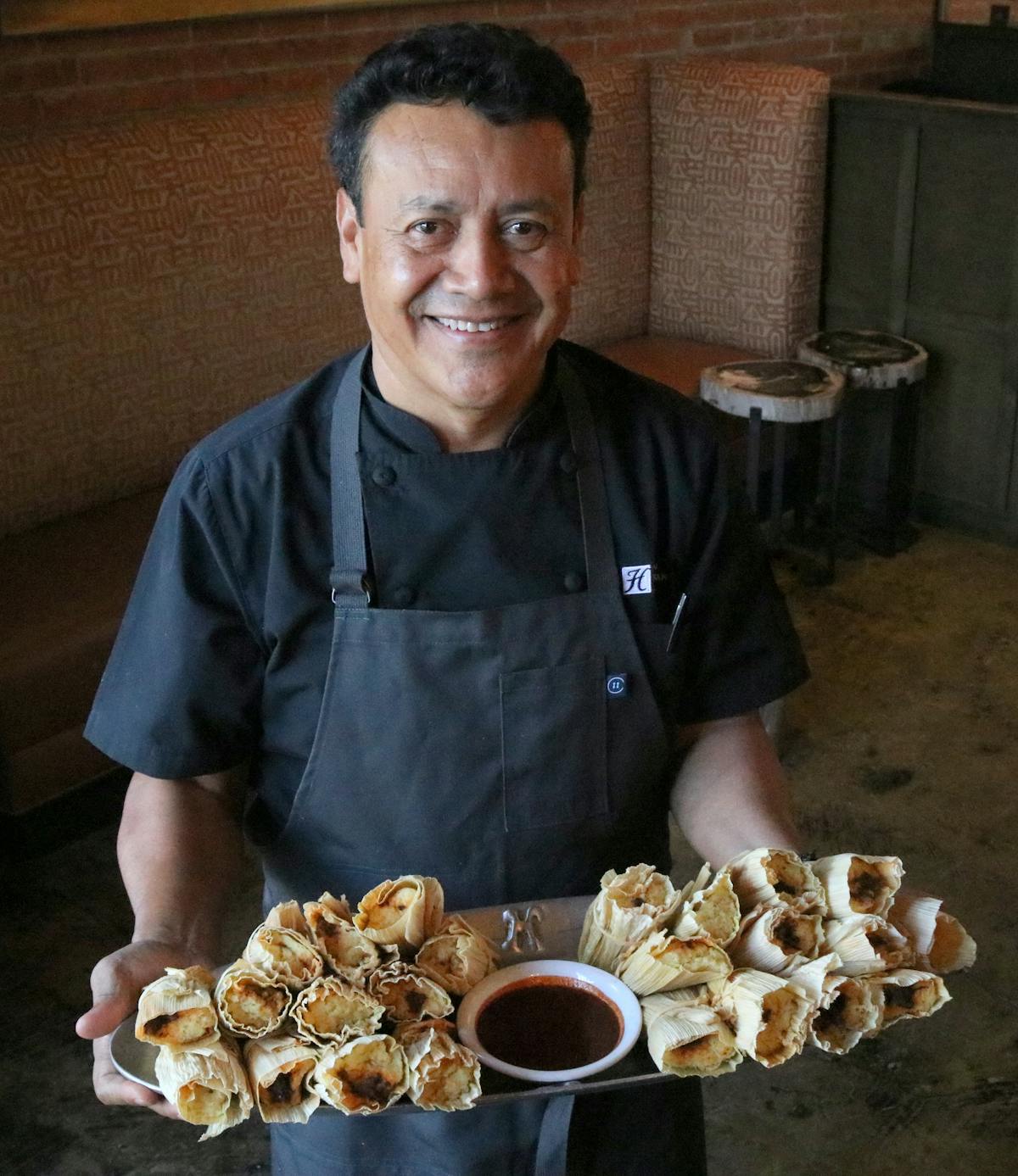 Chef Hugo serving tamales