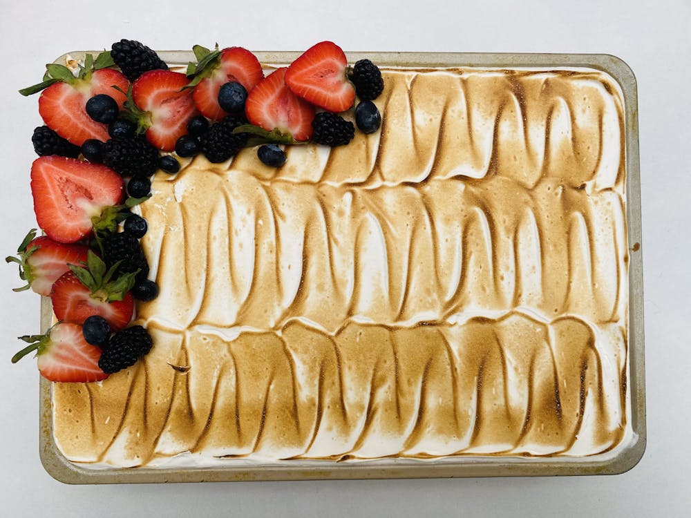 a cake with fruit on top of a table