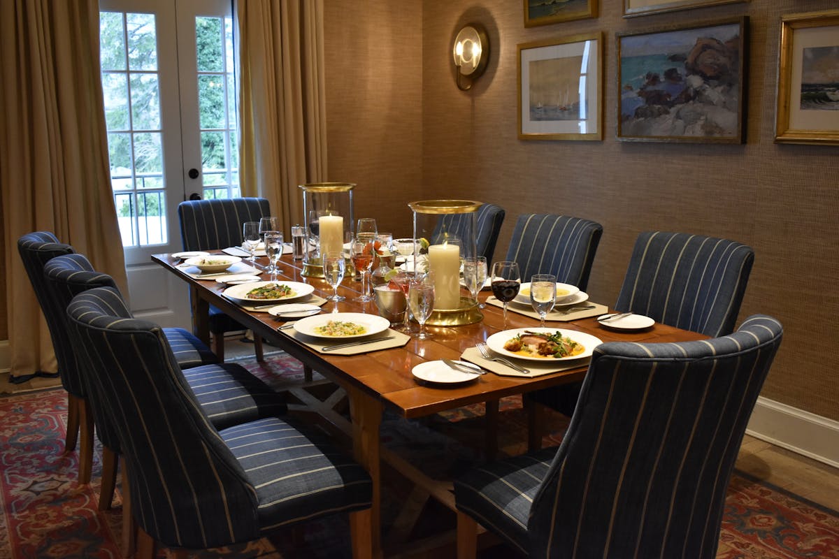 a dining room table in front of a window