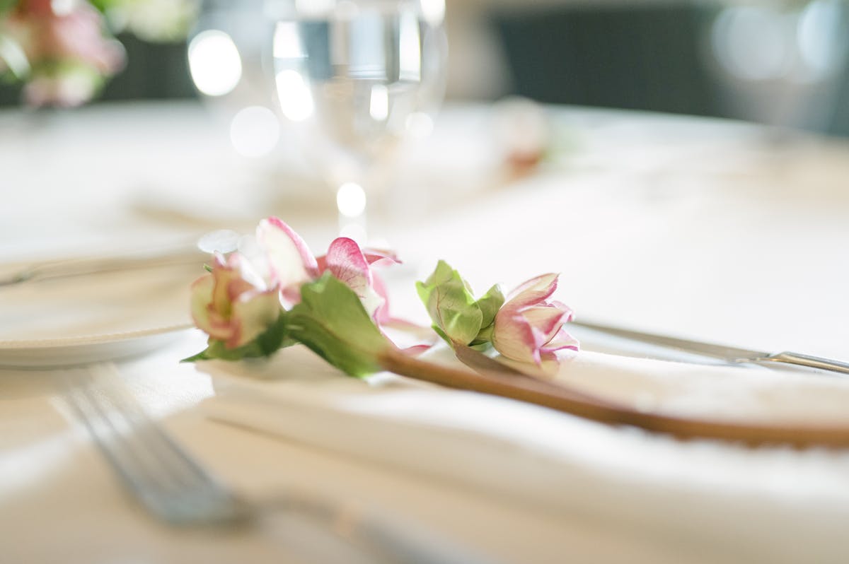 A flower on a table with glasses