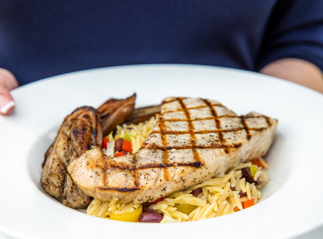 a person sitting at a table with a plate of food