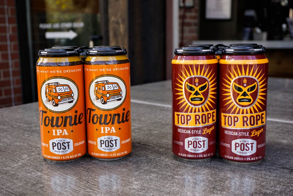 a close up of a bottle and a glass of orange juice