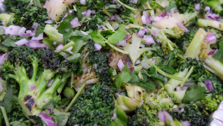 a close up of a salad and broccoli